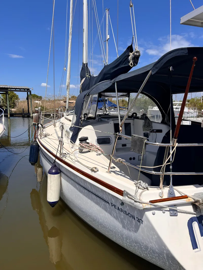 Slide: The Image of 1990 Pearson 37-2 sailboat docked in harbor on a sunny day. - 15