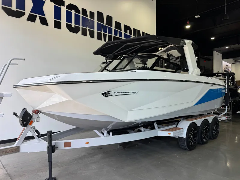 Slide: The Image of 2022 Nautique Super Air Nautique G23 on trailer in showroom. - 2