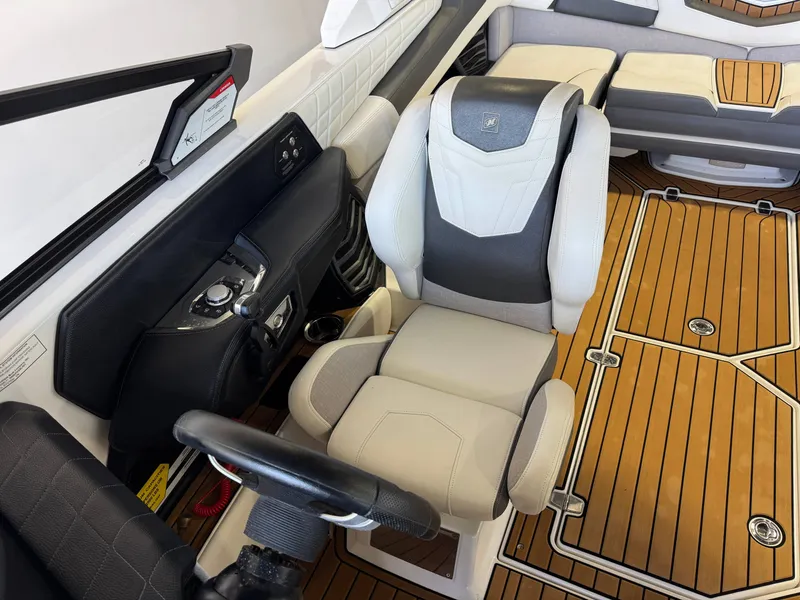 Slide: The Image of Interior of 2022 Nautique Super Air Nautique G23 with luxurious seating and controls. - 21