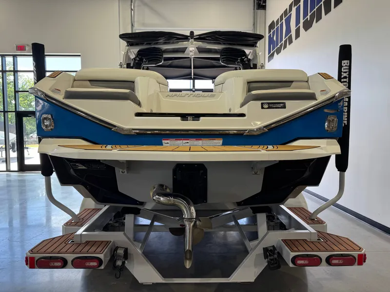 Slide: The Image of Rear view of a 2022 Nautique Super Air Nautique G23 boat in showroom. - 6