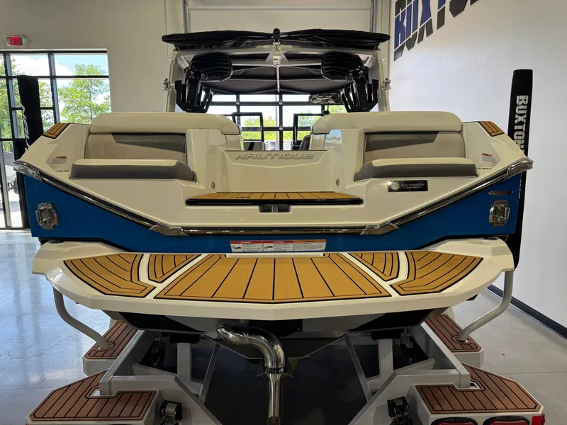 Slide: The Image of Rear view of 2022 Nautique Super Air Nautique G23 boat in showroom. - 8