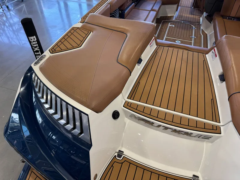 Slide: The Image of 2019 Nautique Super Air Nautique G25 boat rear with brown upholstery. - 12