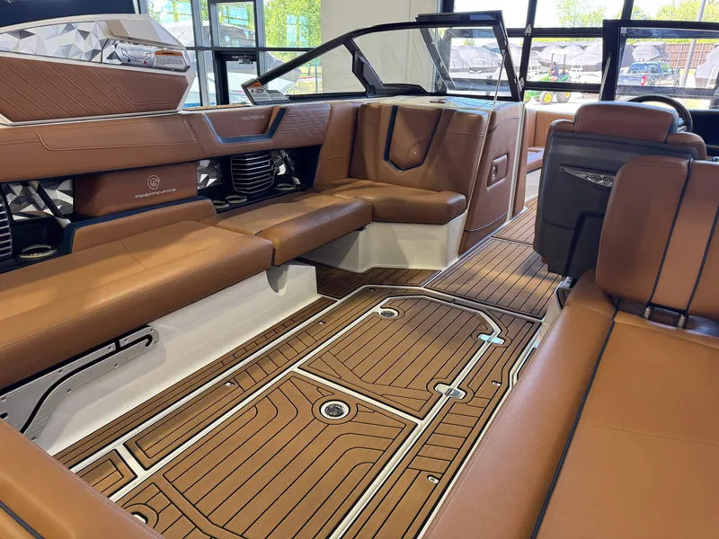 Slide: The Image of Interior of 2019 Nautique Super Air Nautique G25 with brown leather seating. - 14