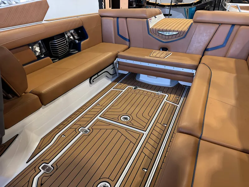 Slide: The Image of Interior of 2019 Nautique Super Air Nautique G25 with brown leather seating. - 15