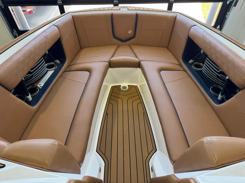 Slide: The Image of Interior of 2019 Nautique Super Air Nautique G25 with brown leather seating. - 17