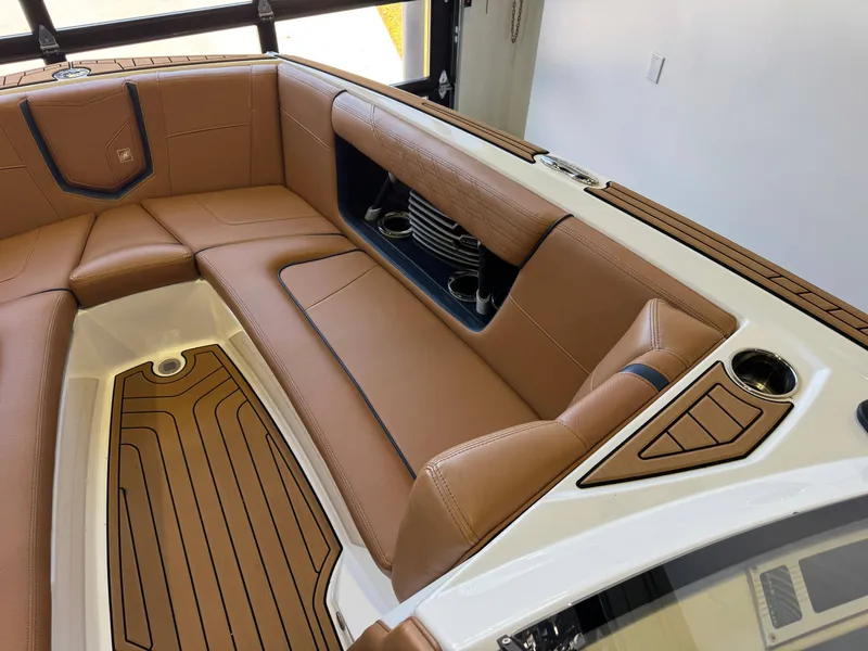 Slide: The Image of Interior of 2019 Nautique Super Air Nautique G25 with brown leather seating. - 18