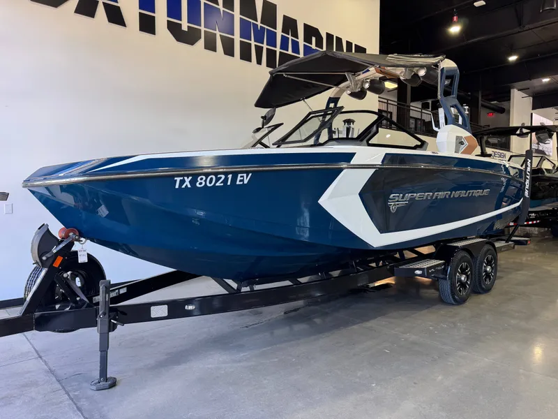Slide: The Image of 2019 Nautique Super Air Nautique G25 boat in showroom. - 2