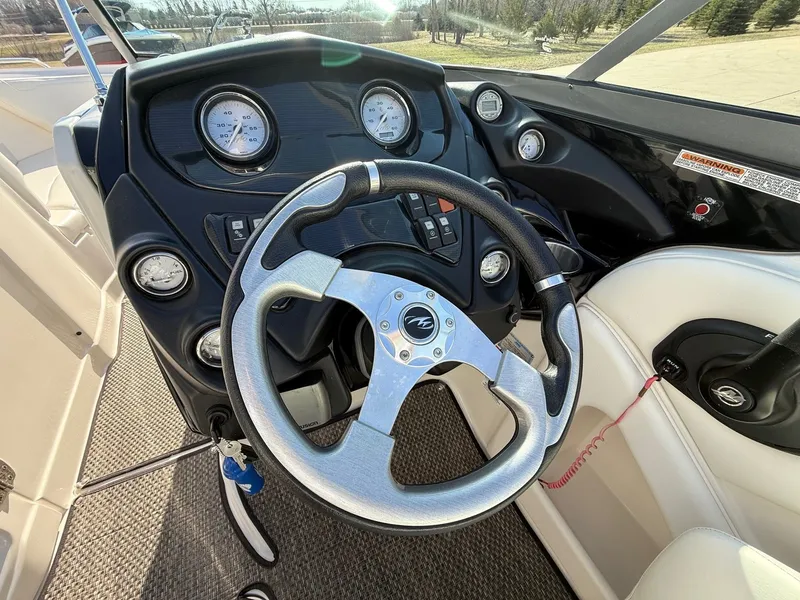 Slide: The Image of Steering wheel and dashboard of a 2012 Monterey 264FS boat. - 14