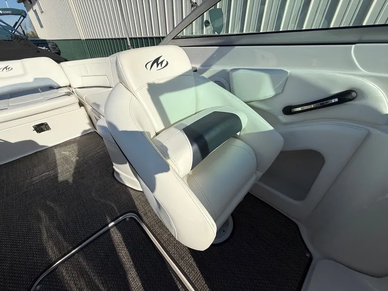 Slide: The Image of Interior of a 2012 Monterey 264FS boat with white leather seats. - 19