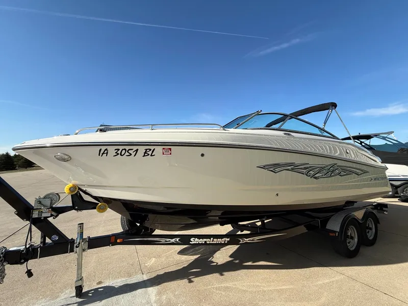 Slide: The Image of 2012 Monterey 264FS boat on trailer under blue sky. - 2