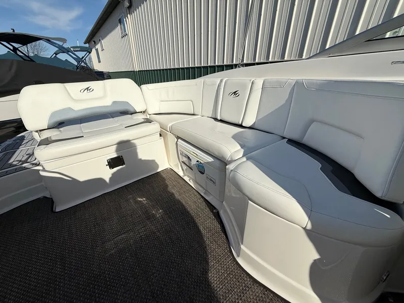 Slide: The Image of Interior of a 2012 Monterey 264FS boat with white leather seating. - 22