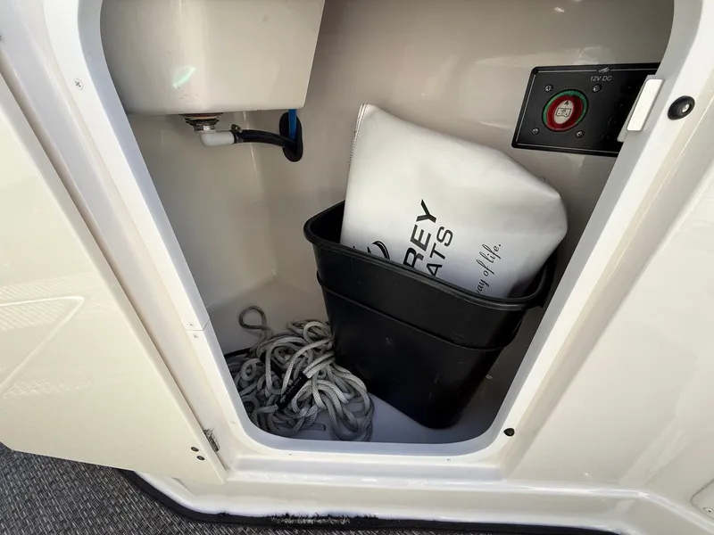 Slide: The Image of Storage compartment in Monterey 264FS boat with rope and accessories. - 25