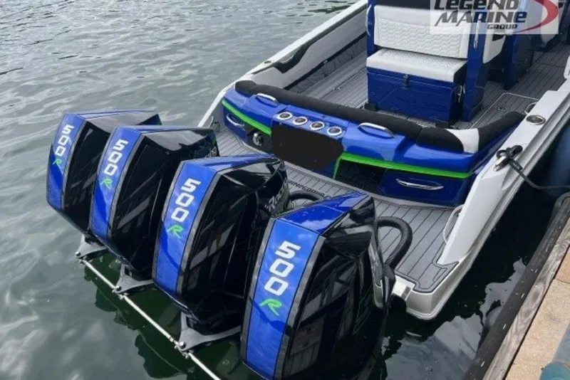 Slide: The Image of 2024 Nor-Tech 390 Sport Center Console with quad 500R engines docked on water. - 4