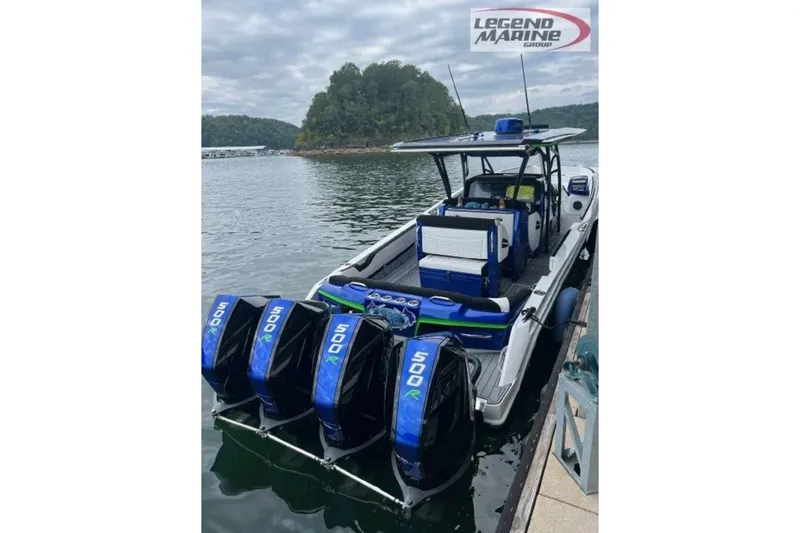 Slide: The Image of 2024 Nor-Tech 390 Sport Center Console boat with quad 500R engines docked on a lake. - 5