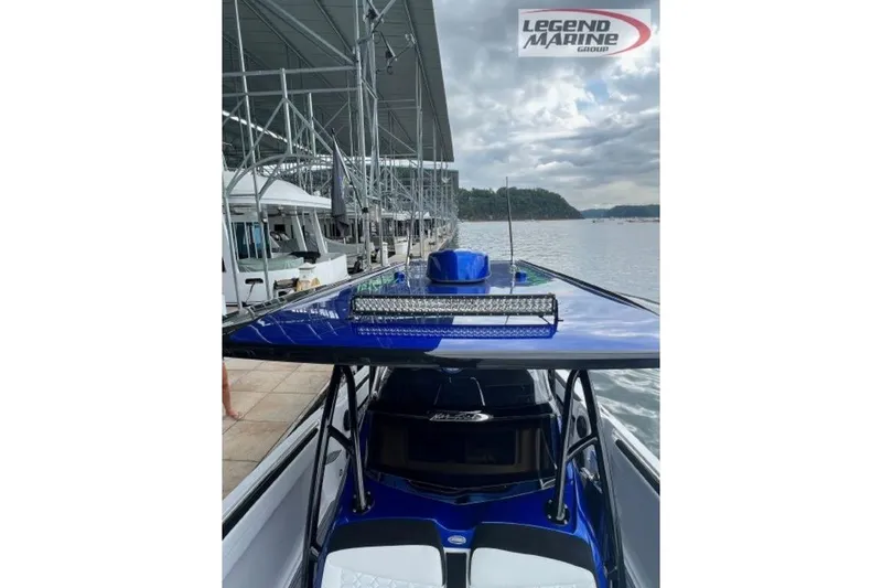 Slide: The Image of 2024 Nor-Tech 390 Sport Center Console boat docked at marina, featuring sleek blue design. - 6