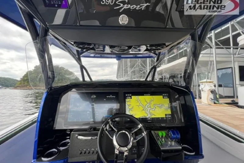 Slide: The Image of 2024 Nor-Tech 390 Sport Center Console dashboard with navigation screens and steering wheel. - 7