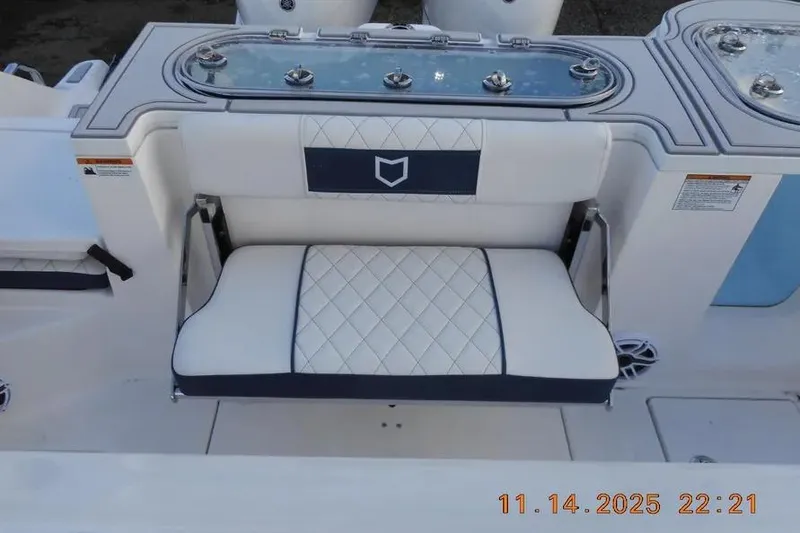 Slide: The Image of 2026 Sea Fox 288 Commander boat seat with diamond-pattern upholstery and storage compartment. - 14