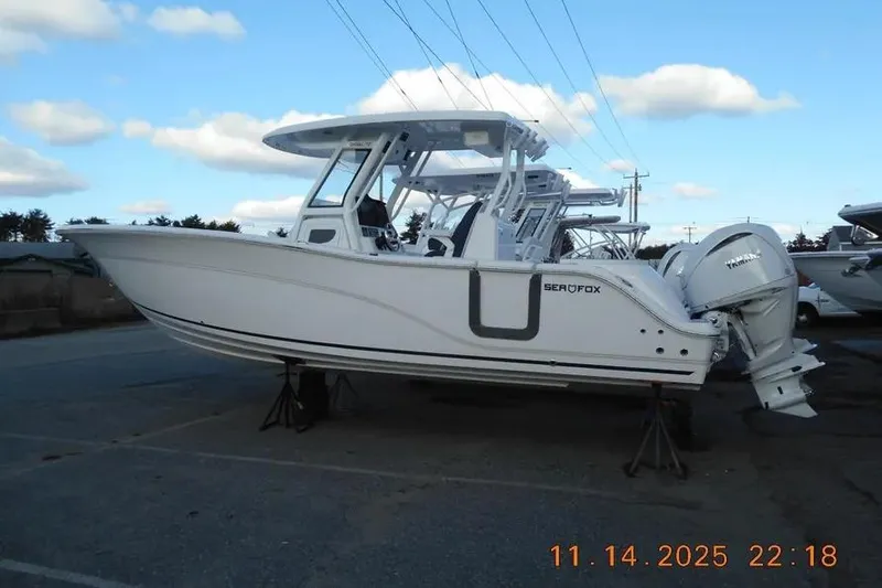 Slide: The Image of 2026 Sea Fox 288 Commander boat on stands, side view, clear sky background. - 3