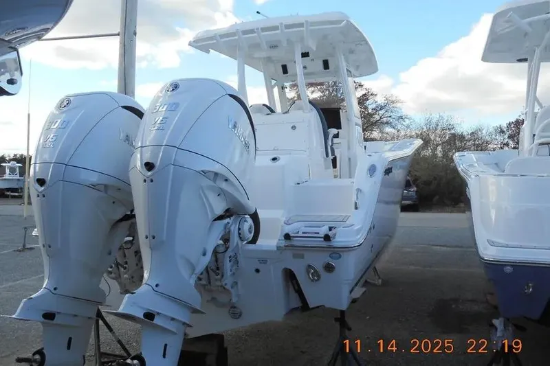 Slide: The Image of 2026 Sea Fox 288 Commander boat with dual Yamaha outboard engines, parked outdoors. - 4