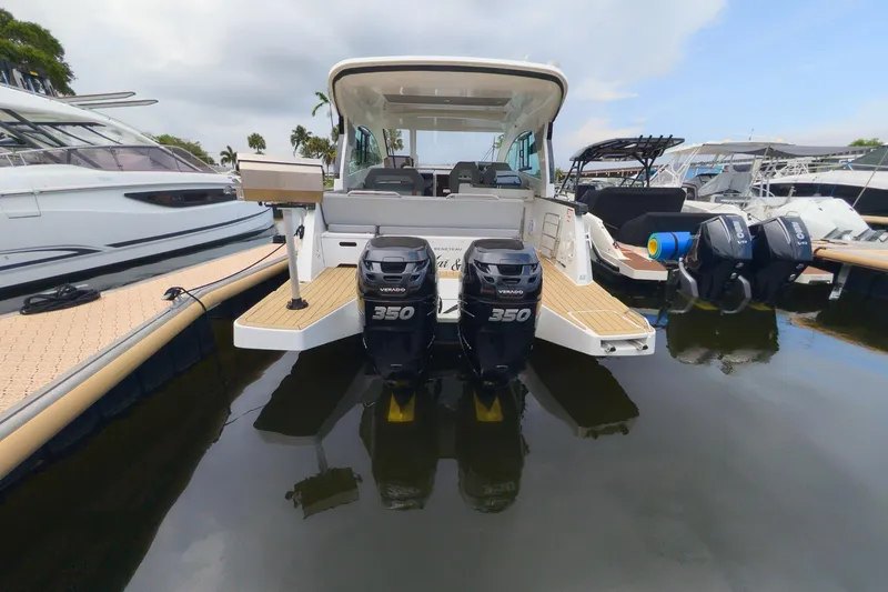 Slide: The Image of 2023 Beneteau Gran Turismo 32 with twin 350 Verado engines docked at marina. - 15