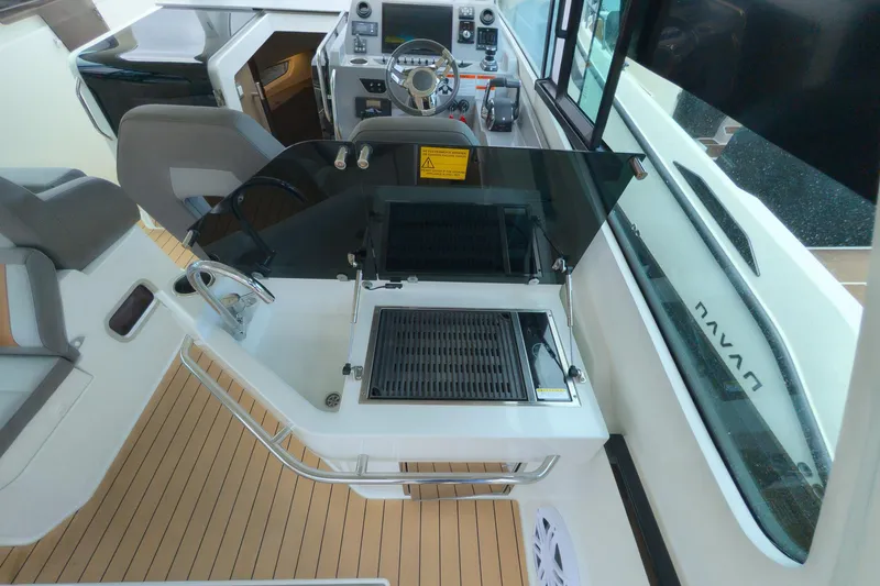 Slide: The Image of 2023 Beneteau Gran Turismo 32 cockpit with grill and steering wheel, featuring modern design. - 16