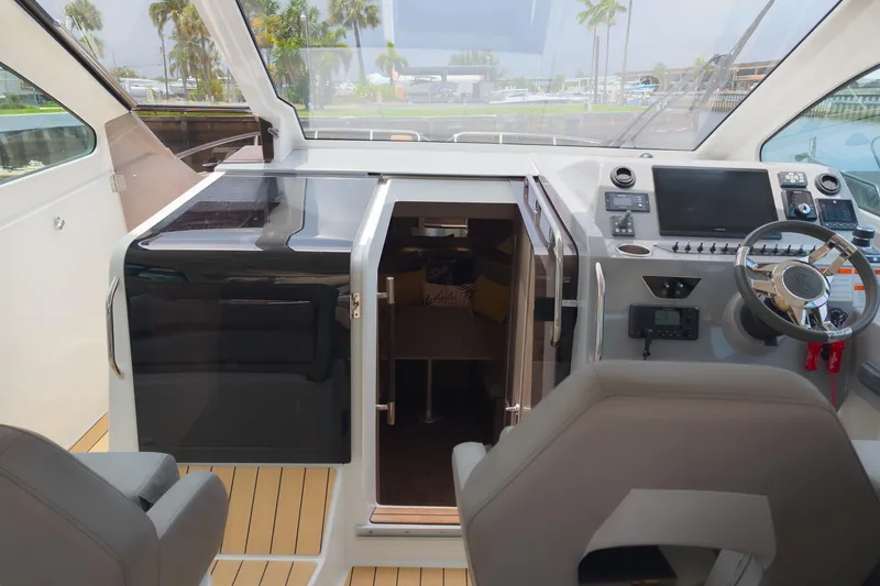 Slide: The Image of 2023 Beneteau Gran Turismo 32 cockpit with modern helm and cabin entrance. - 17