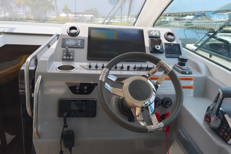 Slide: The Image of Control panel of 2023 Beneteau Gran Turismo 32 yacht with steering wheel and navigation equipment. - 18