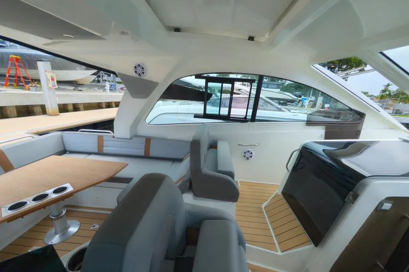 Slide: The Image of Interior of 2023 Beneteau Gran Turismo 32 yacht with modern seating and wooden flooring. - 22