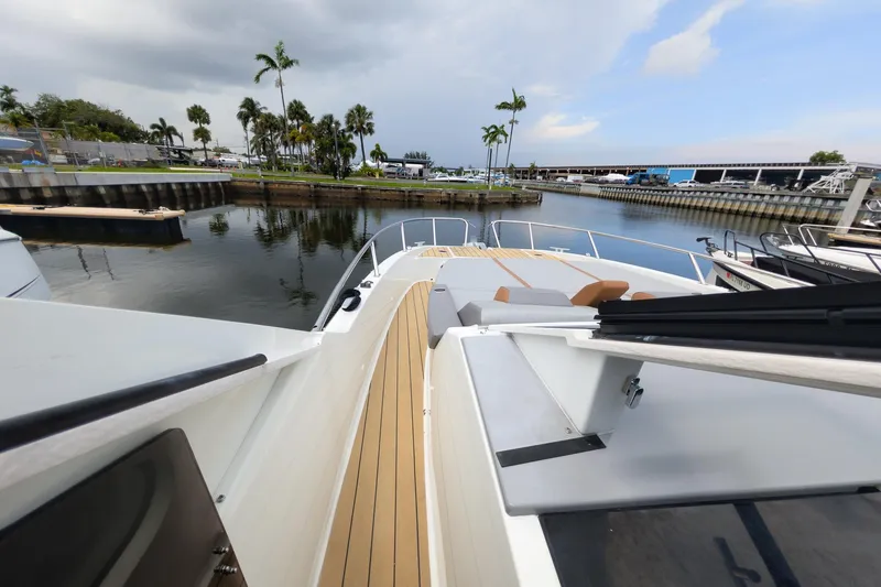 Slide: The Image of 2023 Beneteau Gran Turismo 32 yacht docked, featuring sleek deck design and waterfront view. - 26