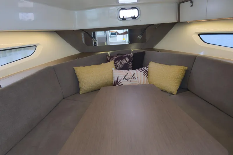 Slide: The Image of Interior of 2023 Beneteau Gran Turismo 32 yacht with cozy seating and decorative pillows. - 29