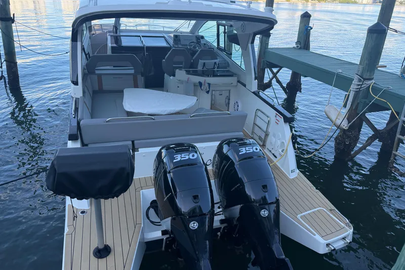 The Image of 2023 Beneteau Gran Turismo 32 yacht with twin 350 engines docked by the water. - 3