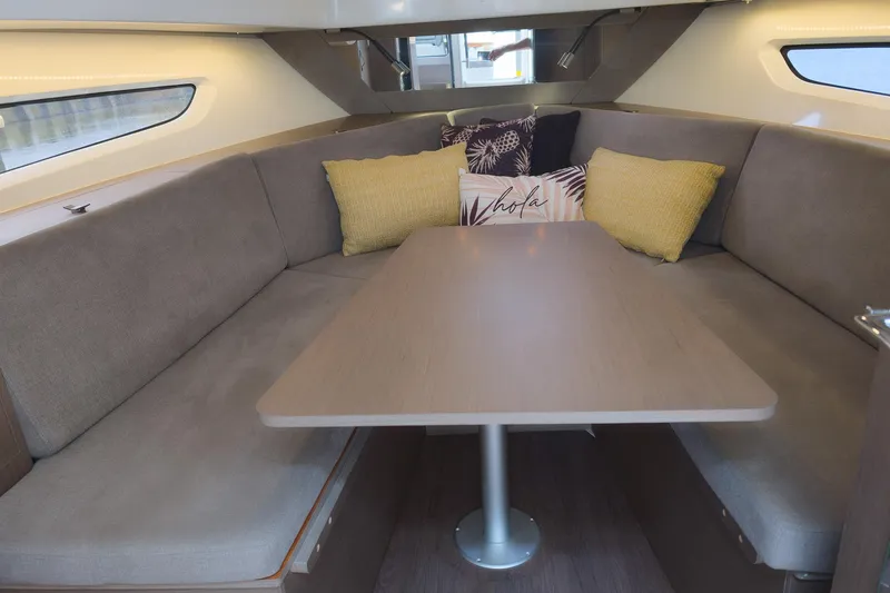 Slide: The Image of Interior of 2023 Beneteau Gran Turismo 32, featuring cozy seating and decorative cushions. - 30