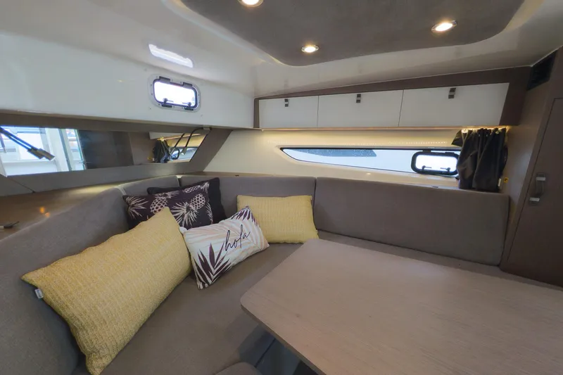 Slide: The Image of Interior of 2023 Beneteau Gran Turismo 32 yacht with cozy seating and decorative pillows. - 36