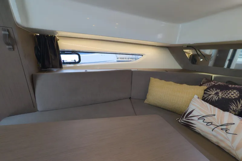 Slide: The Image of Interior of 2023 Beneteau Gran Turismo 32 yacht with cozy seating and decorative pillows. - 37