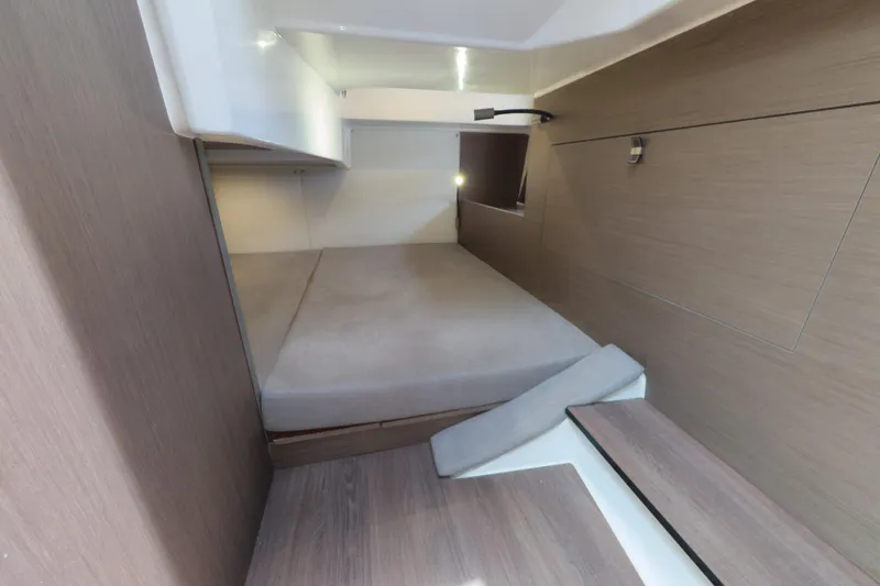Slide: The Image of Interior cabin of 2023 Beneteau Gran Turismo 32, featuring a cozy bed and modern design. - 38
