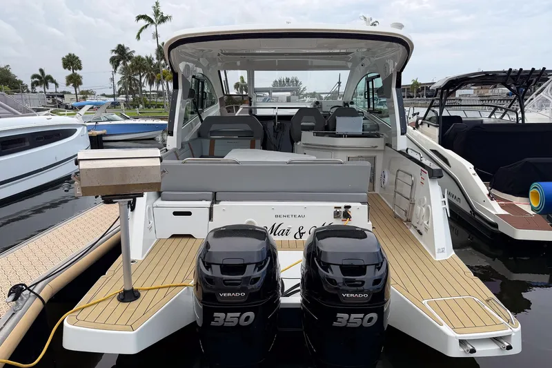 Slide: The Image of 2023 Beneteau Gran Turismo 32 yacht with twin Verado 350 engines docked at marina. - 41
