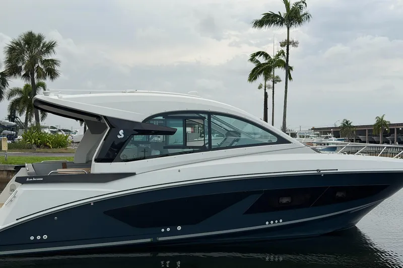 Slide: The Image of 2023 Beneteau Gran Turismo 32 yacht docked near palm trees, showcasing sleek design. - 43