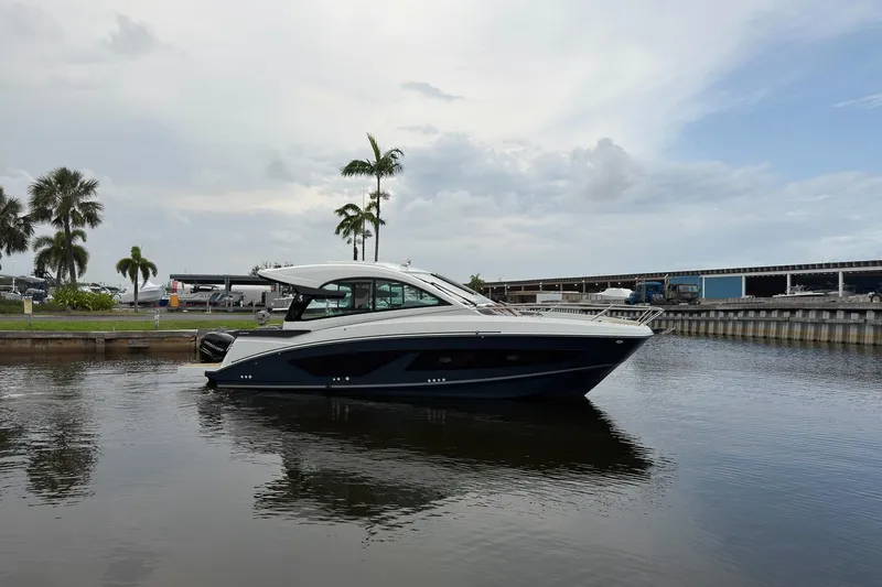 Slide: The Image of 2023 Beneteau Gran Turismo 32 yacht docked in a marina with palm trees. - 46