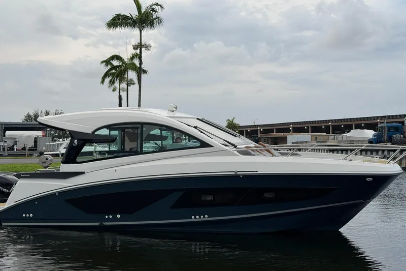 Slide: The Image of 2023 Beneteau Gran Turismo 32 yacht docked, sleek design, palm trees in background. - 47