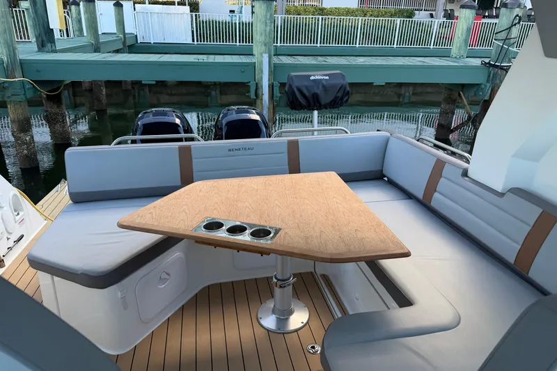 Slide: The Image of Luxurious seating area on 2023 Beneteau Gran Turismo 32 yacht with wooden table. - 5