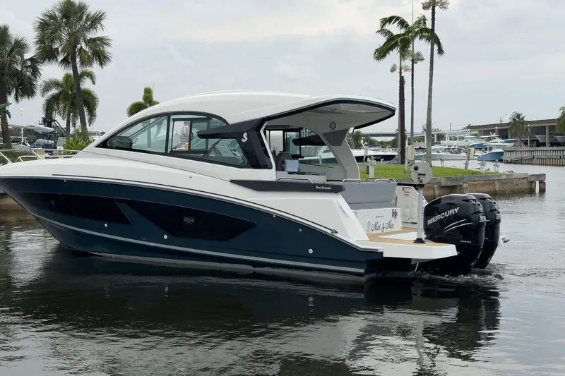 Slide: The Image of 2023 Beneteau Gran Turismo 32 yacht docked, featuring sleek design and powerful Mercury engines. - 55