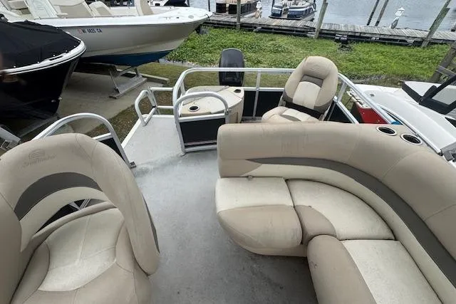 Slide: The Image of 2016 Sun Tracker Bass Buggy 18 DLX pontoon boat with beige seating and spacious deck. - 9