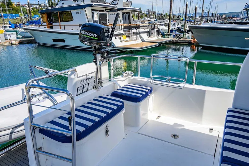 Slide: The Image of Nord Star 28 Patrol 2019 boat interior with striped seating in a marina setting. - 11