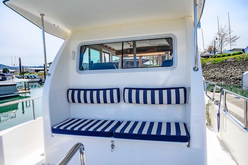 Slide: The Image of Nord Star 28 Patrol 2019 boat with striped seating, docked at a marina. - 12