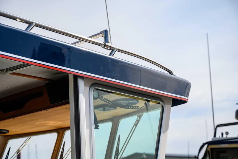 Slide: The Image of Close-up of 2019 Nord Star 28 Patrol boat's cabin with sleek design and railing. - 18
