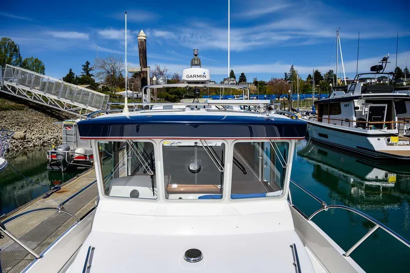 Slide: The Image of 2019 Nord Star 28 Patrol boat docked at a marina under a clear blue sky. - 23