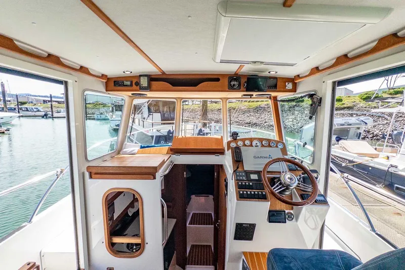 Slide: The Image of Interior of 2019 Nord Star 28 Patrol boat with steering wheel and navigation equipment. - 24