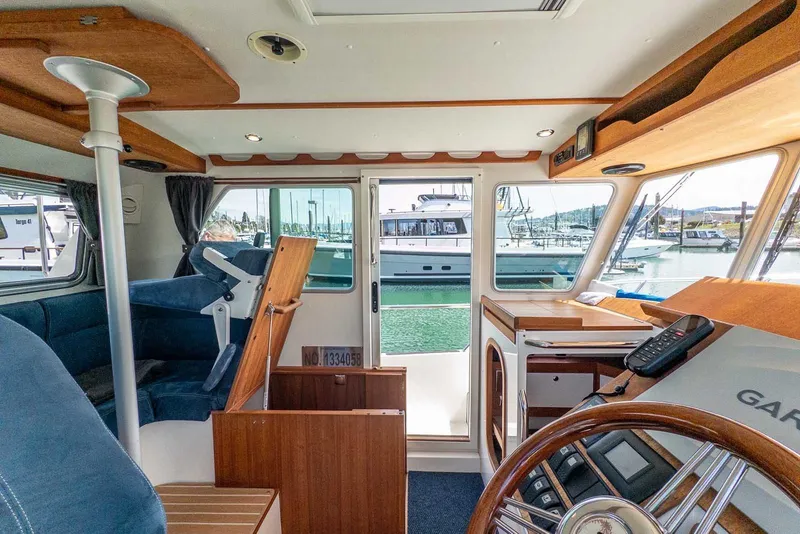 Slide: The Image of Interior of 2019 Nord Star 28 Patrol boat with helm and marina view. - 26