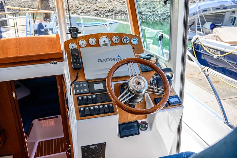 Slide: The Image of Helm of 2019 Nord Star 28 Patrol boat with Garmin navigation system and wooden steering wheel. - 30