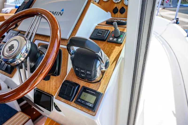 Slide: The Image of Cockpit of 2019 Nord Star 28 Patrol boat with wooden steering wheel and control panel. - 33